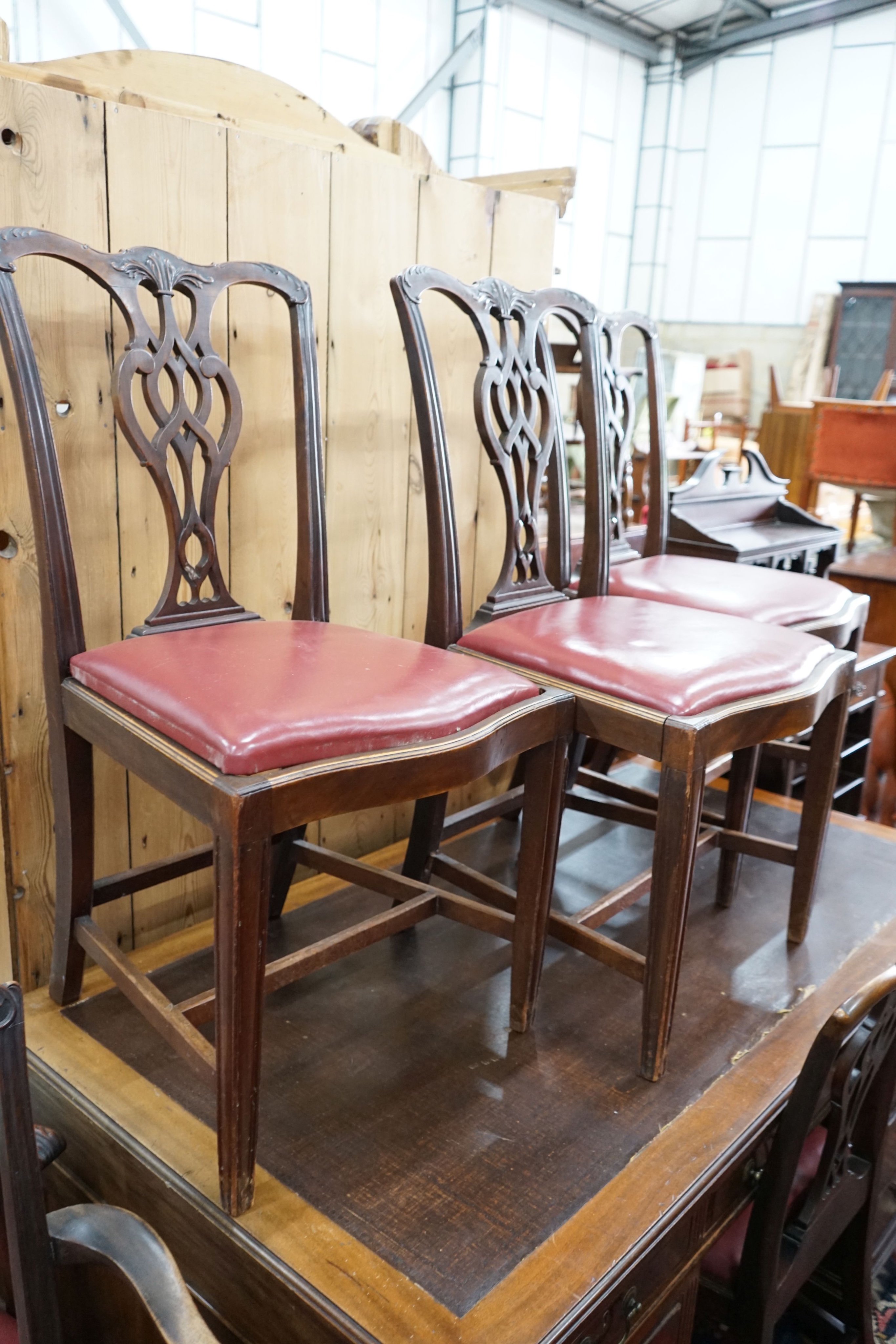 A set of eight Chippendale revival mahogany dining chairs with pierced splats, two with arms
